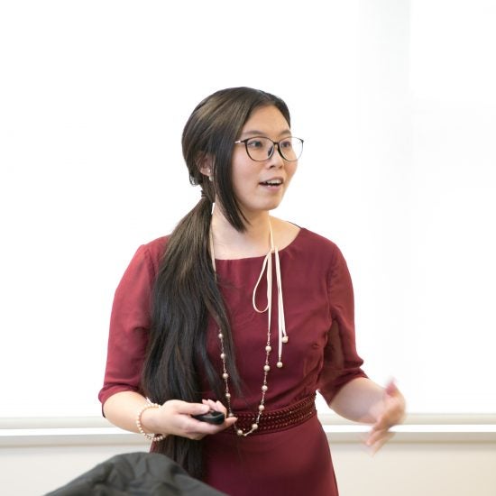 a student talking in front of a whiteboard