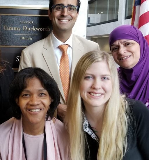 a group picture of 8 Illinois LEND faculty and trainees together in front of Senator Tammy Duckworth’s sign outside her office in Washington DC